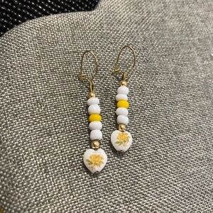 White and Yellow Beaded Pierced Earrings with heart bead with flower detail.